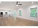 Open-concept living room with hardwood floors seamlessly connects to a modern, well-equipped kitchen at 63 Brookstone E Park, Acworth, GA 30101