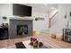 Cozy living room with a fireplace, large TV, decor, and access to the staircase at 63 Brookstone E Park, Acworth, GA 30101
