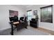 Functional office with multiple monitors, a printer, a dark desk, and natural light at 63 Brookstone E Park, Acworth, GA 30101