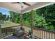 Relaxing covered back porch with comfortable seating and views of the wooded backyard at 63 Brookstone E Park, Acworth, GA 30101