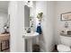 This powder room features a pedestal sink, decorative mirror, and convenient toilet at 63 Brookstone E Park, Acworth, GA 30101