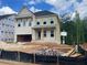 Two-story home under construction with brick facade and open garage at 741 Keystone Dr, Woodstock, GA 30188