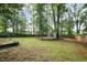 Spacious backyard with a lattice structure, mature trees, and privacy fence at 1491 Kolb Ridge Sw Dr, Marietta, GA 30008