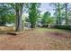 Grassy backyard includes lattice, seating, privacy fence, trees, and access to house at 1491 Kolb Ridge Sw Dr, Marietta, GA 30008