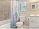 Cozy bathroom features a shower-tub combo with a colorful shower curtain and window at 1491 Kolb Ridge Sw Dr, Marietta, GA 30008