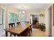 Sunlit dining room with a large wooden table, bench seating, and access to a screened porch at 1491 Kolb Ridge Sw Dr, Marietta, GA 30008
