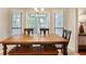 Inviting dining room featuring natural light and a classic wooden table with bench at 1491 Kolb Ridge Sw Dr, Marietta, GA 30008