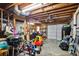 Spacious garage with exposed ceiling, grill, bikes, ’s car, and storage area at 1491 Kolb Ridge Sw Dr, Marietta, GA 30008