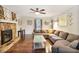 Inviting living room with a stone fireplace, comfortable seating, and a ceiling fan at 1491 Kolb Ridge Sw Dr, Marietta, GA 30008