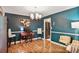 Stylish home office featuring dark blue walls, modern furniture, and hardwood floors at 1491 Kolb Ridge Sw Dr, Marietta, GA 30008