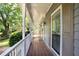 Inviting front porch featuring a white railing and views of the lush greenery at 1491 Kolb Ridge Sw Dr, Marietta, GA 30008