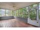 Spacious screened porch with wood flooring, ceiling fan, and scenic views of the backyard at 1491 Kolb Ridge Sw Dr, Marietta, GA 30008