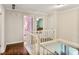 Upstairs hallway with hardwood floors and white banister leads to bedrooms and stairs at 1491 Kolb Ridge Sw Dr, Marietta, GA 30008