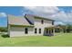 Exterior showcasing the expansive yard with a covered patio offering a comfortable outdoor living space at 211 Linford Dr, Locust Grove, GA 30248