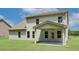 New construction home boasting a large backyard, covered patio, and well-maintained lawn at 211 Linford Dr, Locust Grove, GA 30248