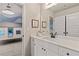 Clean bathroom featuring white cabinets, a white countertop, and a view into a bedroom at 211 Linford Dr, Locust Grove, GA 30248
