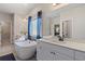 The luxurious bathroom features a soaking tub and dual vanities at 211 Linford Dr, Locust Grove, GA 30248