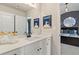 Neutrally painted bathroom with a large mirror, white vanity, and a view into the bedroom at 211 Linford Dr, Locust Grove, GA 30248