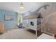 Charming bedroom with unique house-shaped bed, ocean-themed decor, and ample natural light at 211 Linford Dr, Locust Grove, GA 30248