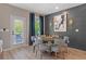 Dining area featuring a modern round table, six chairs, accent wall and stylish decor at 211 Linford Dr, Locust Grove, GA 30248