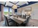 Elegant dining area featuring coffered ceilings, ample natural light, wainscoting, and a stylish dining set at 211 Linford Dr, Locust Grove, GA 30248