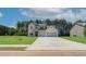 Charming two-story home with a light brick exterior, two-car garage and well-manicured lawn on a sunny day at 211 Linford Dr, Locust Grove, GA 30248