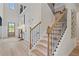 Grand two-story foyer with hardwood stairs, a transom window, and an entry door at 211 Linford Dr, Locust Grove, GA 30248