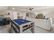 Spacious game room showcasing a pool table, wet bar, comfortable seating, and stylish design elements at 211 Linford Dr, Locust Grove, GA 30248