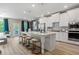 Spacious kitchen with a large center island with stool seating, stainless appliances, and adjacent living area at 211 Linford Dr, Locust Grove, GA 30248