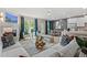 Open living area showcasing a fireplace, large windows with blue curtains, modern decor, and seamless flow to the kitchen at 211 Linford Dr, Locust Grove, GA 30248