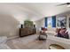 Bright living room featuring plush white sofa, modern furniture, and a large flat-screen television at 211 Linford Dr, Locust Grove, GA 30248