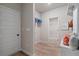 Functional mudroom includes storage cubbies, shelving, a bench, and a door to the outside, providing organized entryway at 211 Linford Dr, Locust Grove, GA 30248