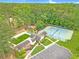 Aerial view of community pool, tennis courts, playground, and clubhouse nestled in lush greenery at 2333 Orion Ct, Grayson, GA 30017
