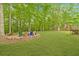 Expansive backyard featuring a cozy fire pit with colorful Adirondack chairs, ideal for gatherings at 2333 Orion Ct, Grayson, GA 30017