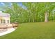 Expansive backyard with lush green lawn and inviting wood deck, perfect for outdoor activities at 2333 Orion Ct, Grayson, GA 30017