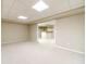Large basement living area featuring carpet and view of the basement bar for easy entertaining at 2333 Orion Ct, Grayson, GA 30017