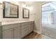 Bathroom featuring double vanity, framed mirrors, and wood-look tile flooring at 2333 Orion Ct, Grayson, GA 30017