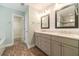 Remodeled bathroom with dual vanities, framed mirrors, shiplap accent wall and wood look floors at 2333 Orion Ct, Grayson, GA 30017