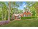 Charming brick home featuring a manicured lawn, lush landscaping, and a welcoming entrance at 2333 Orion Ct, Grayson, GA 30017