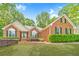 Beautiful brick home with well-maintained landscaping and green shutters at 2333 Orion Ct, Grayson, GA 30017