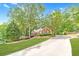 Beautiful brick home featuring a long driveway, lush lawn, and mature landscaping at 2333 Orion Ct, Grayson, GA 30017