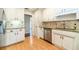Updated kitchen with stainless steel appliances, granite countertops, and light wood floors at 2333 Orion Ct, Grayson, GA 30017