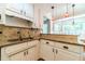 Eat-in kitchen featuring granite countertops, stainless steel sink, and neutral backsplash at 2333 Orion Ct, Grayson, GA 30017