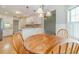 Kitchen area with light colored cabinets, stainless appliances and a wooden table with four chairs at 2333 Orion Ct, Grayson, GA 30017