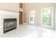 Bright living room with a fireplace and white tile flooring with three large windows at 2333 Orion Ct, Grayson, GA 30017