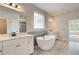 Bright bathroom with dual vanities, soaking tub, and separate shower area at 234 Linford Dr, Locust Grove, GA 30248