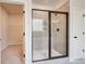 Elegant bathroom with tiled shower, glass door, and access to a walk-in closet at 234 Linford Dr, Locust Grove, GA 30248