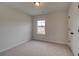 Cozy bedroom with carpeted flooring, closet, and a view of the neighborhood at 234 Linford Dr, Locust Grove, GA 30248