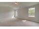 Bright bedroom featuring carpeted floor, vaulted ceiling, and natural light at 234 Linford Dr, Locust Grove, GA 30248