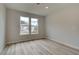 A bright bedroom shows neutral walls, wood flooring, and a double window showcasing the home's exterior at 234 Linford Dr, Locust Grove, GA 30248
